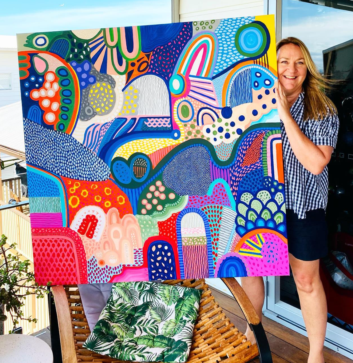 Portrait of Carolyn Burchill with one of her paintings